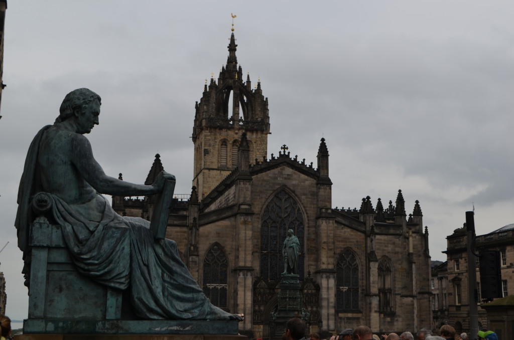The statue of aclaimed Scottish philosopher David Hume with the Saint Giles' Cathedral in the background.